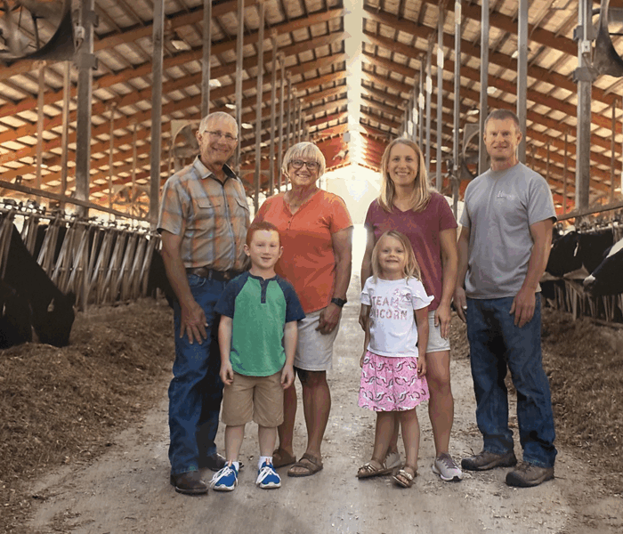 Image of Ruediner family in dairy barn